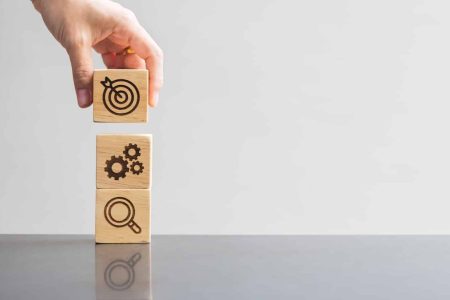 wood block with business goal, strategy, target, mission